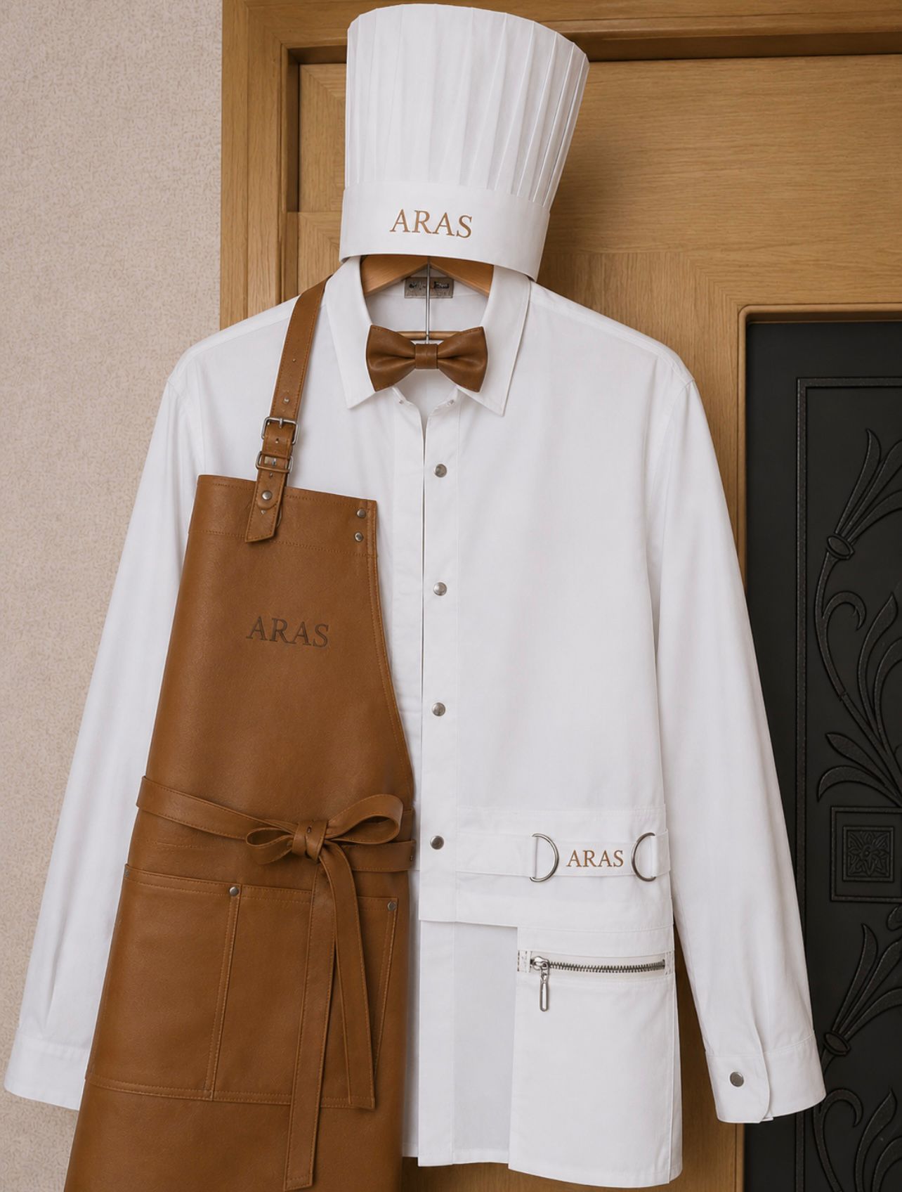ARAS chef set — flat lay of toque, white coat, leather apron